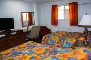 Postel nebo postele na pokoji v ubytování Hotel Paquime