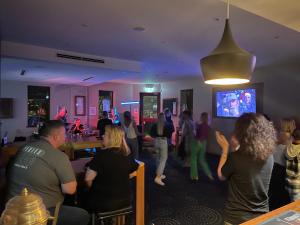 a group of people dancing in a room at Cooma Hotel in Cooma