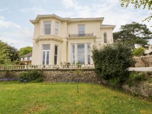a house with a stone wall and a fence at Holcombe House in Torquay