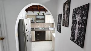 a kitchen with a refrigerator and a sink at amplio y comodo apartamento en envigado in Envigado