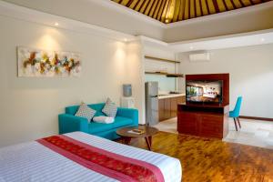 a bedroom with a blue bed and a living room at Sanata Luxury Villa in Canggu
