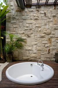 a white sink in front of a stone wall at Sanata Luxury Villa in Canggu