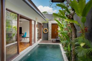 an indoor swimming pool in the backyard of a house at Sanata Luxury Villa in Canggu