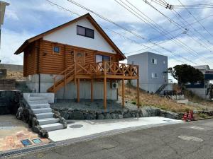 a house with a deck on the side of it at SHIRAHAMA condominium K-32 in Kanayama +9 photos
