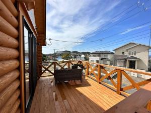 a wooden deck with a bench on top of a house at SHIRAHAMA condominium K-32 in Kanayama