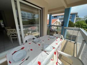 einen Tisch auf einem Balkon mit einem weißen Tischtuch drauf in der Unterkunft Appartement Arcachon, 2 pièces, 4 personnes - FR-1-374-115 in Arcachon