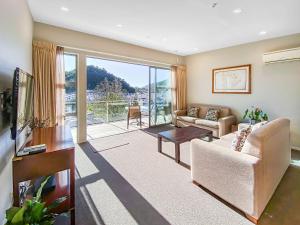 a living room with a couch and a table at The Moorings Waterfront Picton in Picton