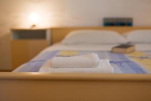 two towels on a bed in a room at Apartment Ivy in Malinska