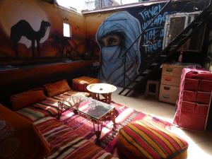 a living room with a couch and a mural at Booking and hosting medina in Casablanca
