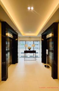 a hallway with a desk in a building at MINIMALIST, STYLISH, ELEGANT - at FAME RESIDENCES in Manila