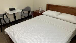 מיטה או מיטות בחדר ב-Sharkat Homestay