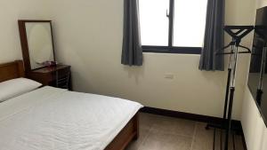 מיטה או מיטות בחדר ב-Sharkat Homestay