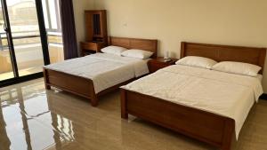 Postel nebo postele na pokoji v ubytování Sharkat Homestay