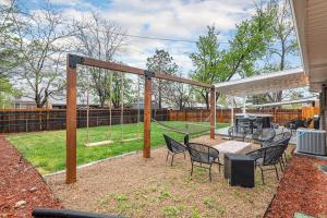 a patio with a table and chairs and a swing at Mile Hi: Amenities Galore in Denver