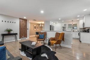a living room and kitchen with a table and chairs at Mile Hi: Amenities Galore in Denver