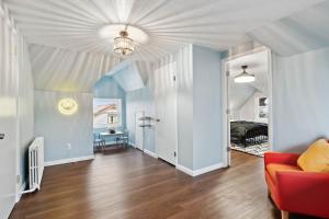 a living room with a couch and a bed at Stay Golden 1: Chic Modern-Victorian City View in Pittsburgh