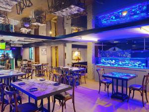 a restaurant with tables and chairs and a bar at GM Hotel and Apartment in Hai Phong