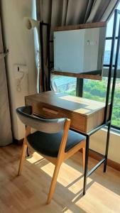 a wooden desk with a chair in front of a window at Imperium Resident Kuantan Eleven-7 in Kuantan
