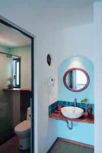 a bathroom with a sink and a mirror at Laholm Hotel - Apartment in Nha Trang