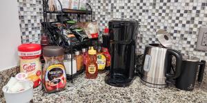 a counter with a bunch of condiments on it at Luxe 3BR Apartment at MIT Harvard with FREE parking in Cambridge