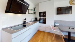 a kitchen with a sink and a dining table at Kapitänshaus Thule Kapitänshaus THULE 5 -Luna- in Langeoog
