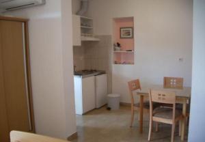 a kitchen and dining room with a table and chairs at Josip II - 150 m from beach in Baška Voda