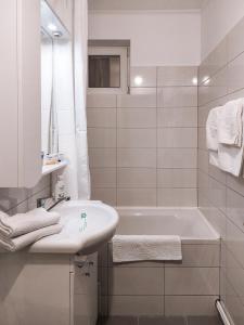 a white bathroom with a sink and a bath tub at Apartament Alina - la parter & parcare rezervata in Deva +29 photos