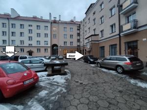 a group of cars parked in a parking lot at Urban Jungle Apartment in the city center in Białystok