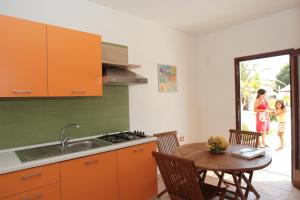 a kitchen with a table and a sink and a woman at Relax in Vieste