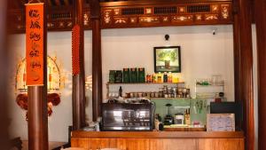 a shop with a counter with a microwave in a room at An Nam Hue Boutique in Cư Chinh