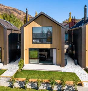 a house with a large window in a yard at Cardrona Black Diamond Apartment in Cardrona