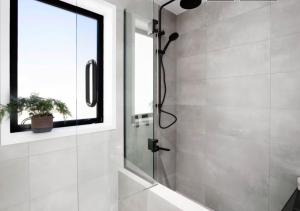 a shower with a glass door in a bathroom at Cardrona Black Diamond Apartment in Cardrona