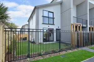 a black fence in front of a house at Sea air and Sandy Beach, beautiful 1 bed 1 bath in Christchurch