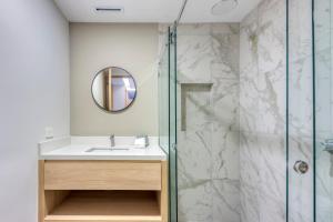 a bathroom with a sink and a shower at Lumina at Cardinal San José del Cabo in San José del Cabo