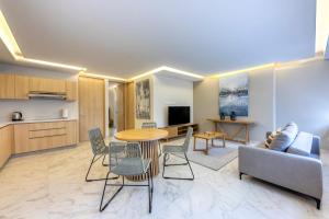 a living room with a table and chairs and a kitchen at Lumina at Cardinal San José del Cabo in San José del Cabo