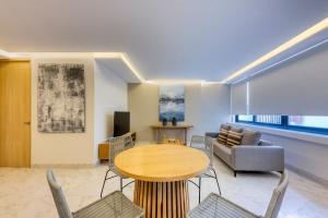 a living room with a table and chairs and a couch at Lumina at Cardinal San José del Cabo in San José del Cabo