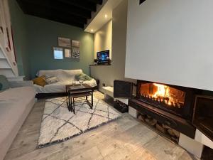 a living room with a fireplace and a couch at Rev d’Opale in Wimereux