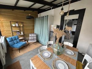 a dining room with a table and a blue chair at Rev d’Opale in Wimereux +28 photos