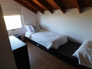 a bedroom with two beds and a window at MI CASA TU CASA in El Calafate