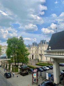 a large building with cars parked in a parking lot at Central Family Boutique Apartments 3 in Lviv +41 photos