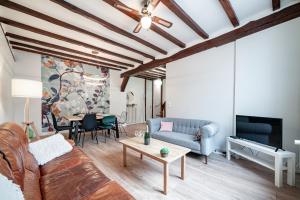 un salon avec un canapé et une table dans l'établissement Les Mansardes : Duplex champenois typique et cosy, à Ay