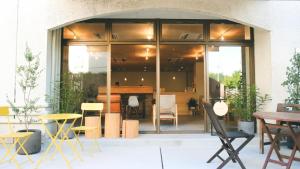 a room with a table and chairs in a building at ASA Village in Shirahama