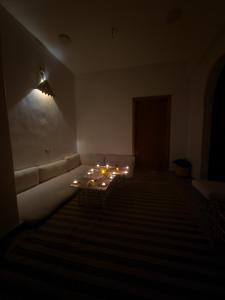 a living room with a couch and candles on a table at SEMIRAmis Siwa in Siwa