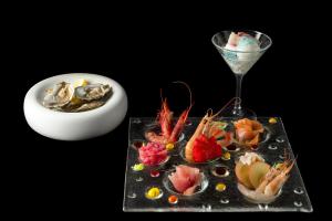 a table with a plate of food and a wine glass at Resort Miramonti in Forte dei Marmi