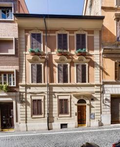 a building with windows and doors on a street at CLASSIC FLAT boschetto in Rome
