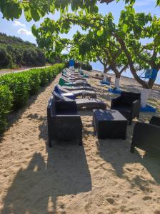 a row of lounge chairs on a sandy beach at Bella Vista in Yiáltra
