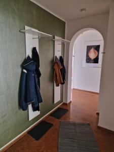 a hallway with coats hanging on a wall at Ferienwohnung Milan in Oberstaufen