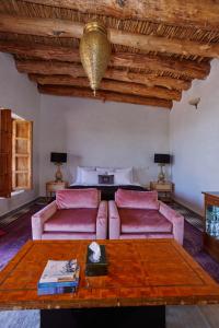 a living room with a couch and a bed at Dar Imiri in Ourika