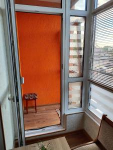 a door to a balcony with a bench and a window at Новобудова Центр Либiдь Плаза in Khmelnytskyi