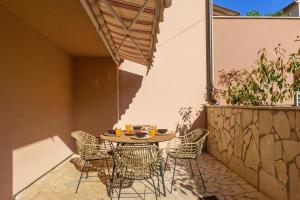 a patio with a table and chairs on a patio at Studio Apartment Mali in Medulin